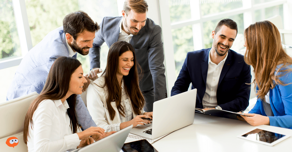 A photo of a business marketing team happily analyzing marketing data